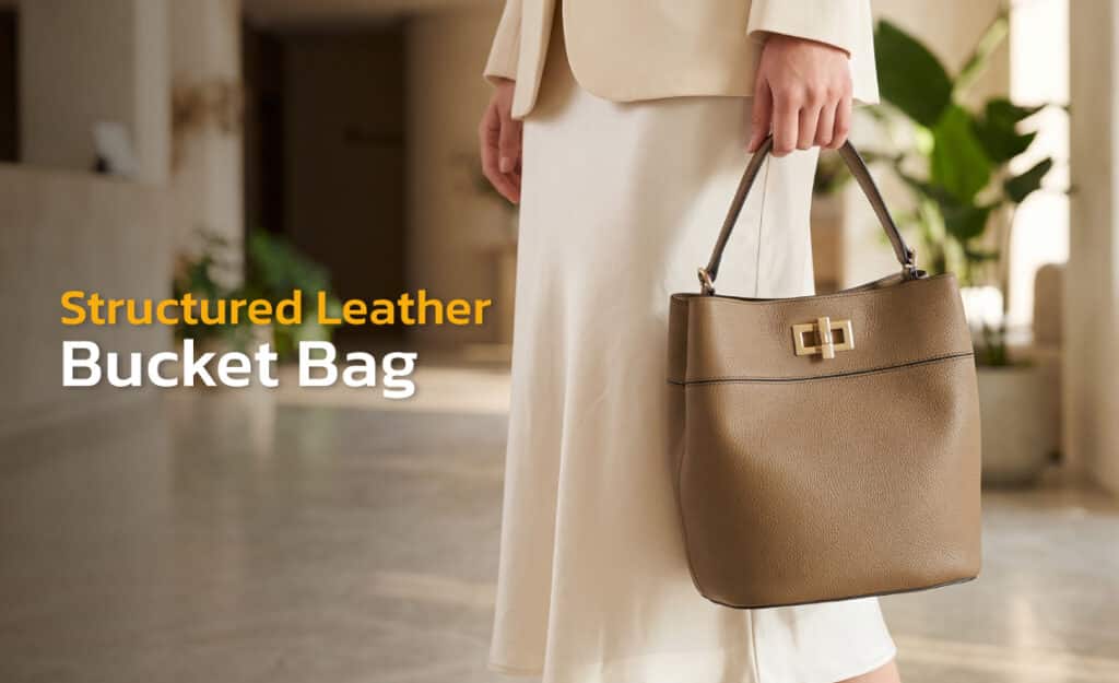 Structured leather bucket bag with magnetic snap closure, made by Suvino.